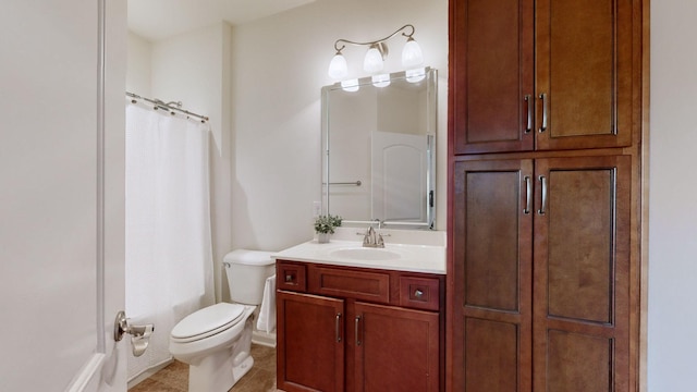 bathroom with a shower with curtain, vanity, toilet, and tile patterned floors