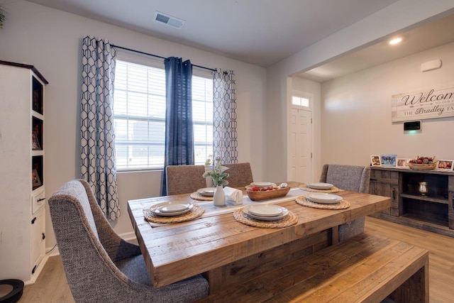 dining area featuring light wood-type flooring and a wealth of natural light