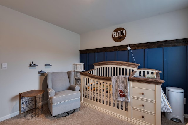 bedroom with a crib and carpet floors