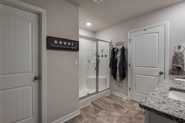 bathroom featuring vanity and a shower with shower door