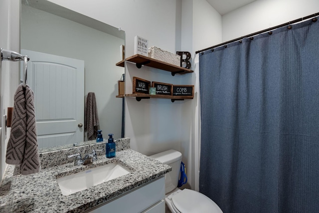 bathroom featuring vanity and toilet