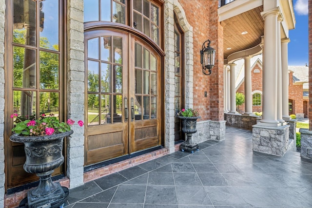 entrance to property with covered porch and french doors