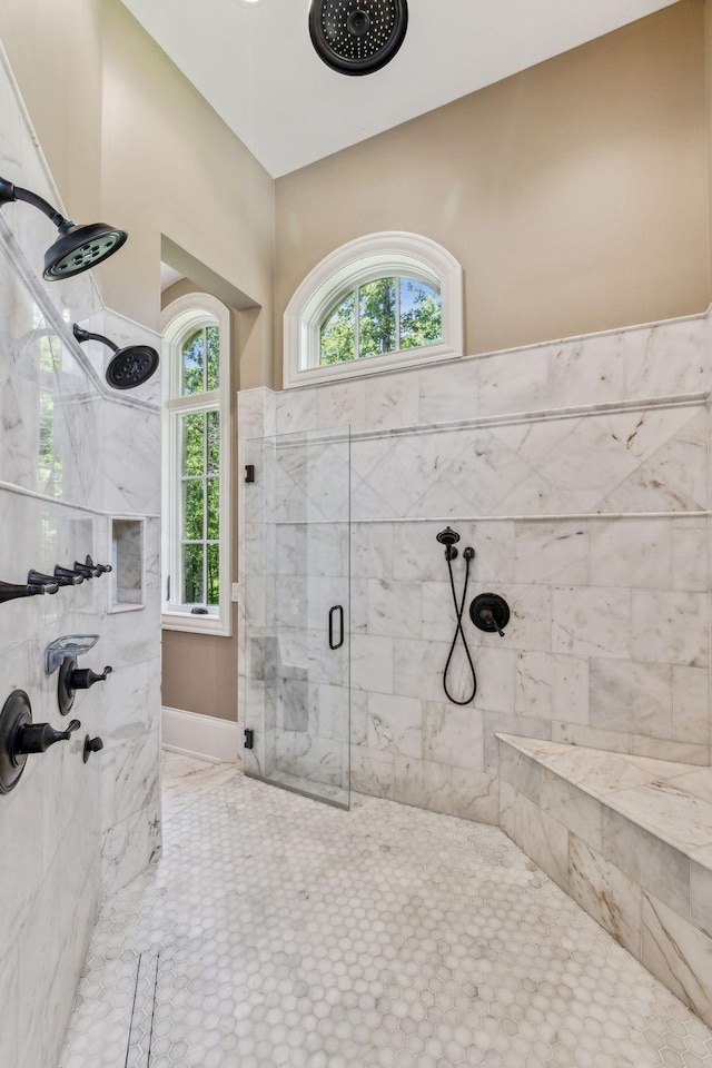 bathroom featuring a wealth of natural light and a shower with door