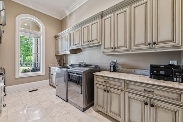 laundry area with sink, independent washer and dryer, and crown molding