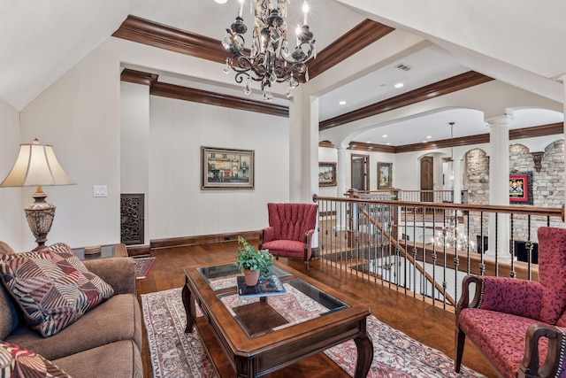 living room with hardwood / wood-style floors, a chandelier, ornamental molding, and decorative columns