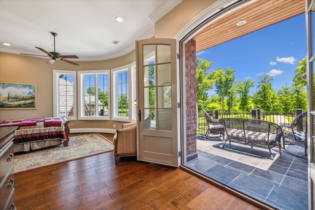 entryway with ceiling fan, ornamental molding, and dark wood-type flooring