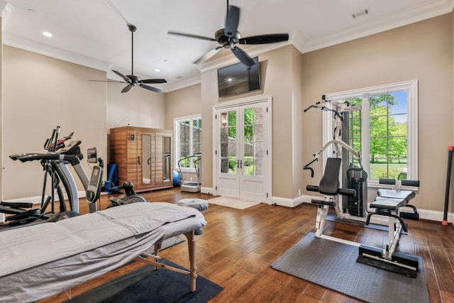 workout room with ceiling fan, dark hardwood / wood-style flooring, and ornamental molding