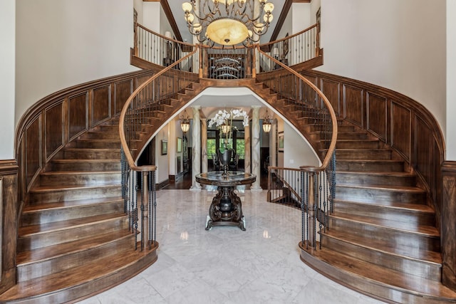 entrance foyer featuring a high ceiling, french doors, and a notable chandelier