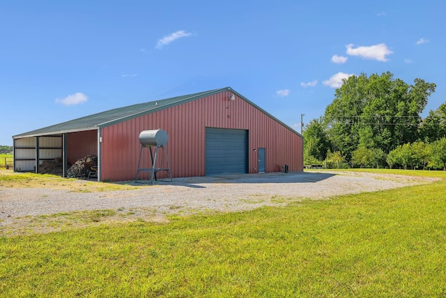 view of outdoor structure with a yard and a garage