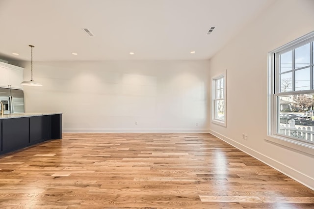 unfurnished living room featuring light wood-type flooring