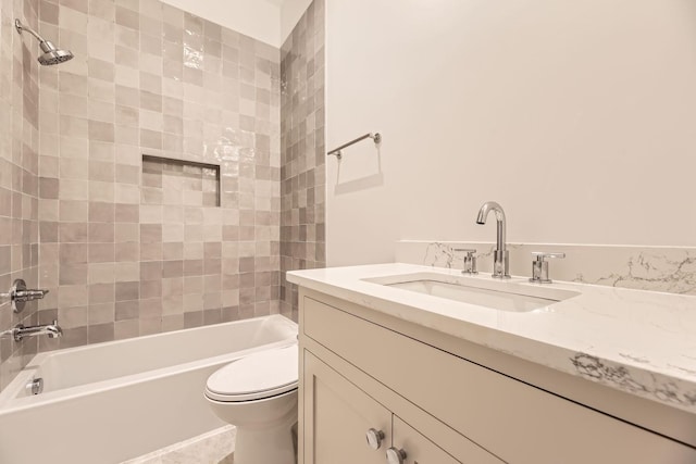 full bathroom featuring vanity, tiled shower / bath combo, and toilet