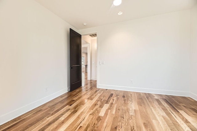 spare room with light hardwood / wood-style flooring