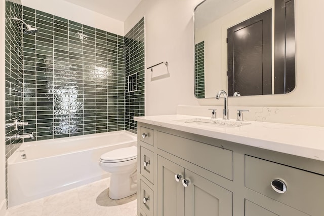 full bathroom featuring vanity, tile patterned flooring, tiled shower / bath, and toilet