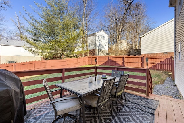 wooden deck featuring a lawn and area for grilling