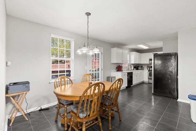 dining room with sink and a chandelier