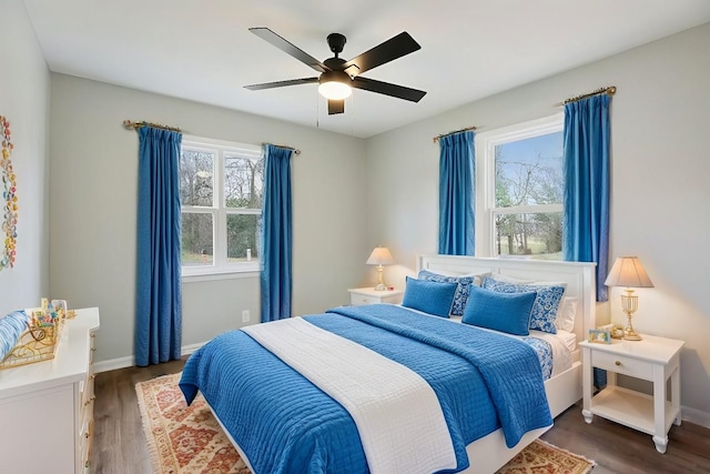 bedroom with ceiling fan and dark wood-type flooring