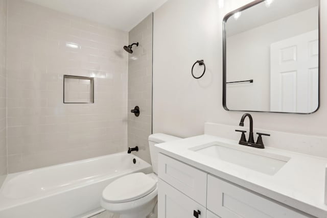 full bathroom with vanity, toilet, and tiled shower / bath