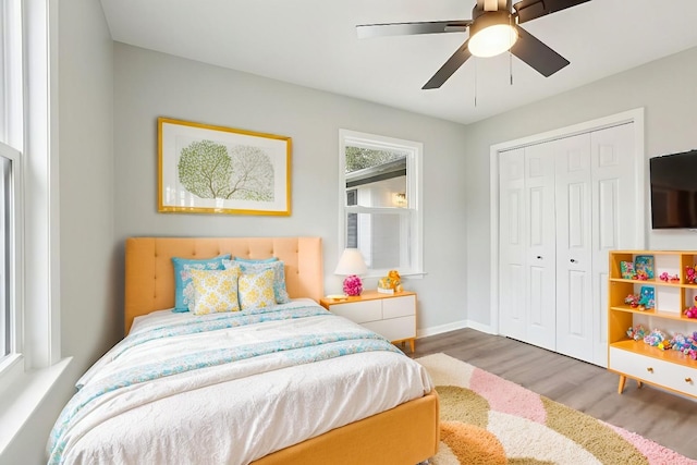 bedroom featuring ceiling fan, a closet, and hardwood / wood-style flooring