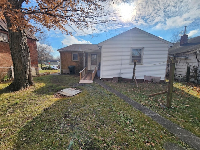 rear view of house with a yard