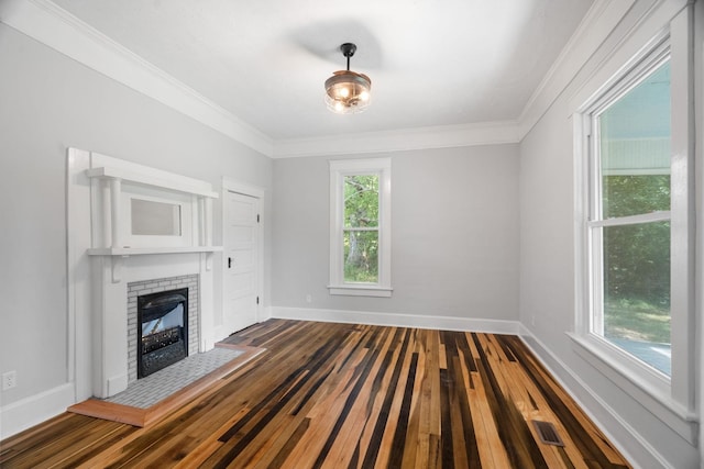 unfurnished living room featuring a fireplace, dark hardwood / wood-style floors, and crown molding