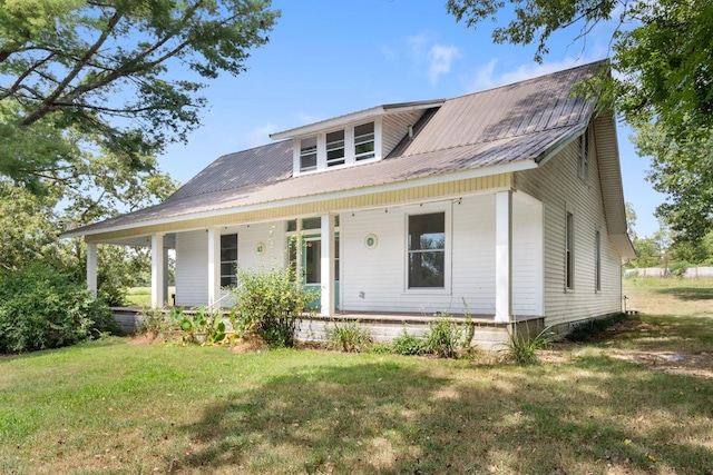 view of front of house with covered porch and a front yard