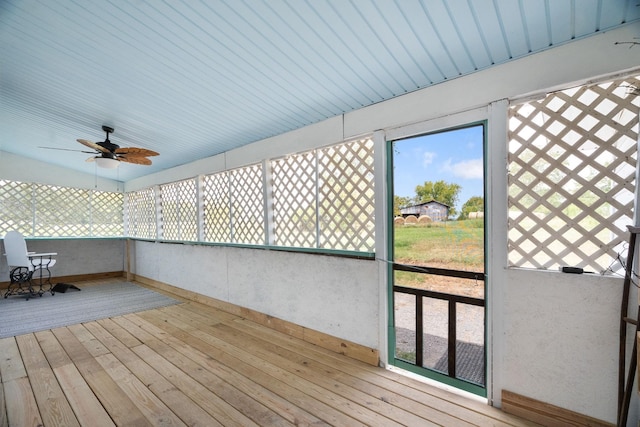 unfurnished sunroom featuring a wealth of natural light and ceiling fan