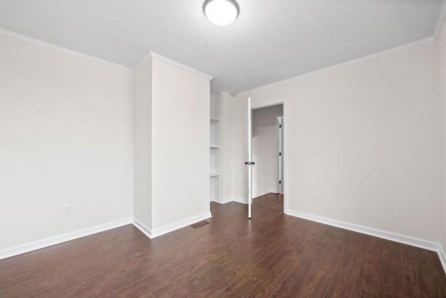 empty room with dark hardwood / wood-style flooring and ornamental molding