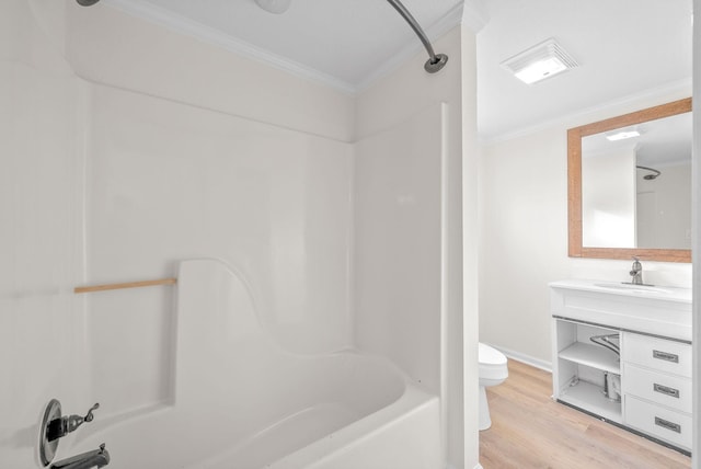 full bathroom with washtub / shower combination, wood-type flooring, toilet, vanity, and ornamental molding