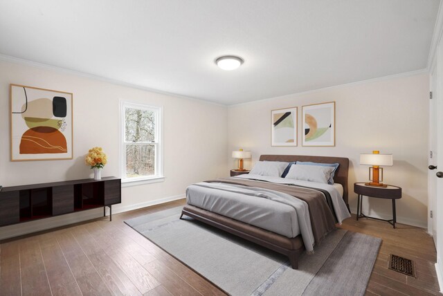 bedroom featuring hardwood / wood-style floors and ornamental molding