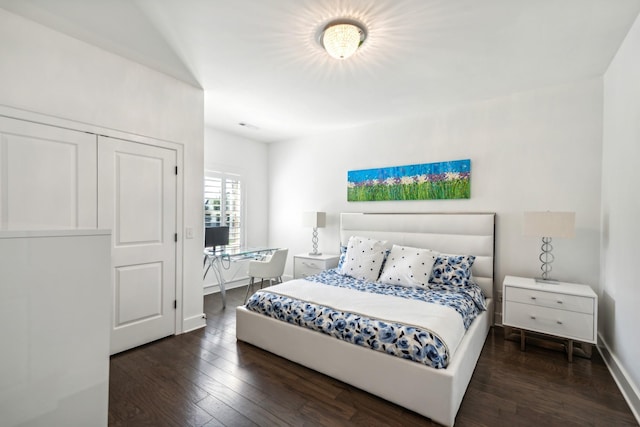 bedroom with dark hardwood / wood-style floors