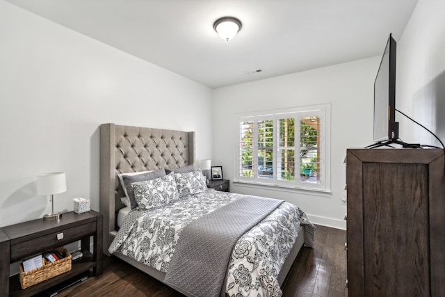 bedroom with dark wood-type flooring