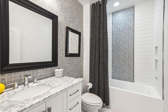 full bathroom with vanity, toilet, decorative backsplash, and tiled shower / bath combo