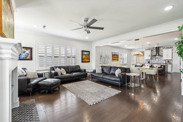 living room with dark hardwood / wood-style floors, ceiling fan, and crown molding