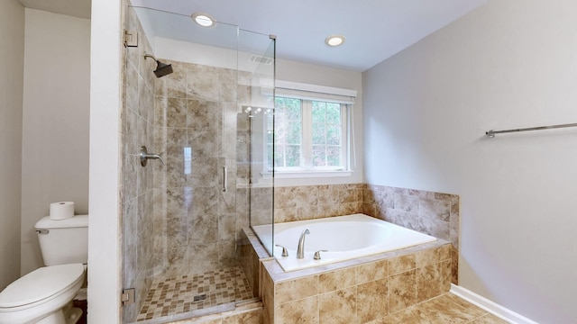 bathroom featuring tile patterned flooring, separate shower and tub, and toilet