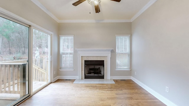 unfurnished living room featuring ceiling fan, light wood-type flooring, and ornamental molding