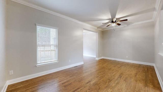 spare room with hardwood / wood-style floors, ceiling fan, and crown molding