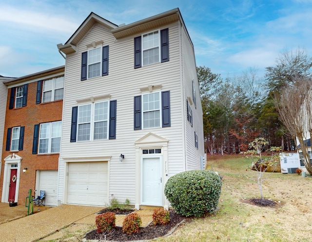 view of front facade with a front yard and a garage