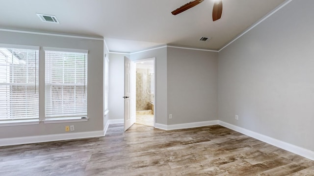 empty room with ceiling fan, wood-type flooring, and crown molding