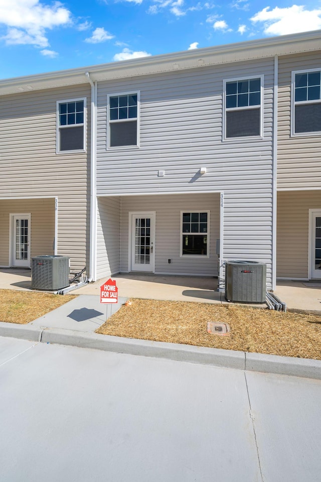 back of house with central AC unit