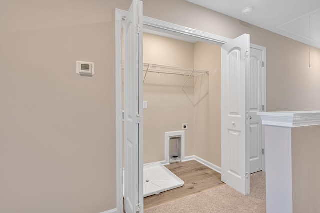 laundry room featuring electric dryer hookup and light carpet