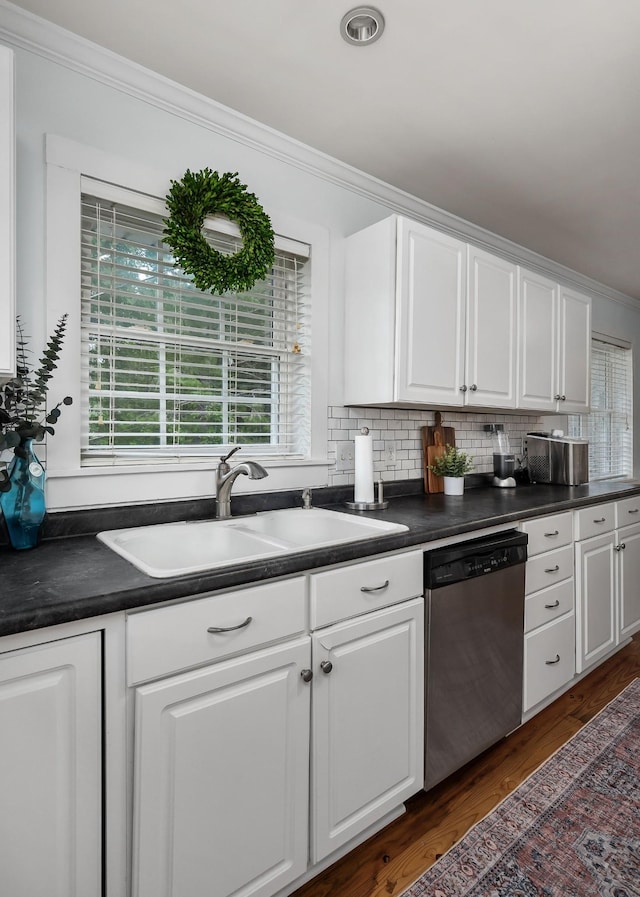 kitchen featuring sink, stainless steel dishwasher, dark hardwood / wood-style floors, ornamental molding, and white cabinetry