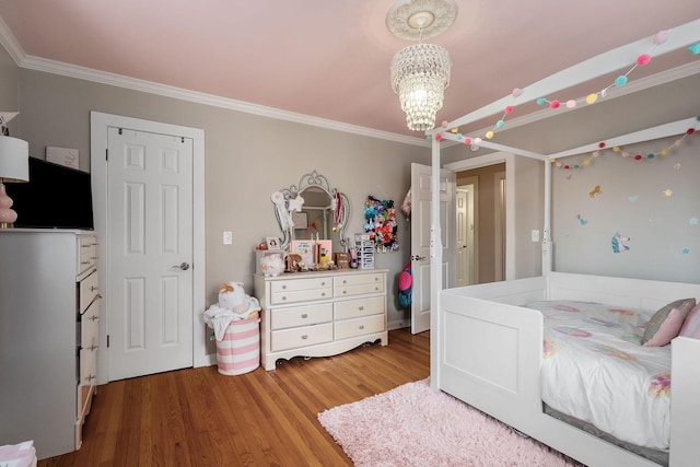 bedroom featuring hardwood / wood-style flooring, a notable chandelier, and ornamental molding