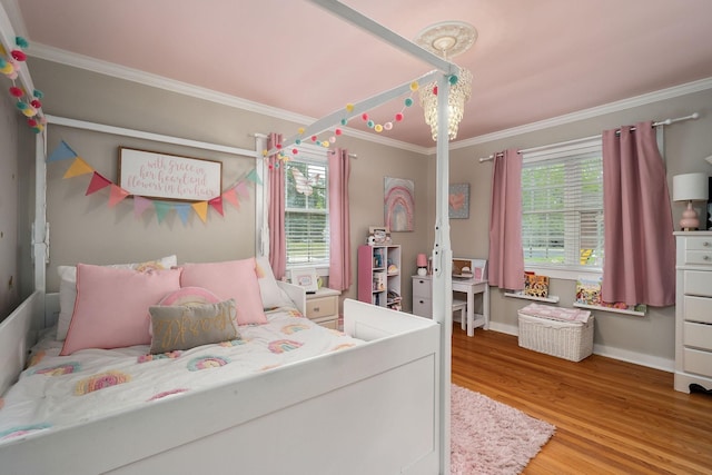 bedroom with hardwood / wood-style floors and crown molding