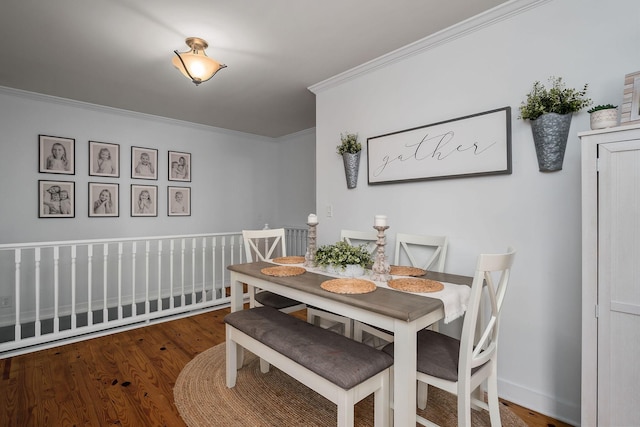 dining space featuring wood-type flooring and ornamental molding