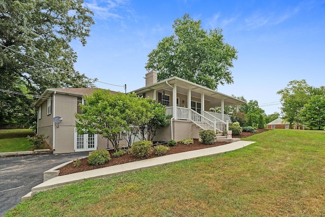 view of front of home with french doors, a front lawn, and a porch