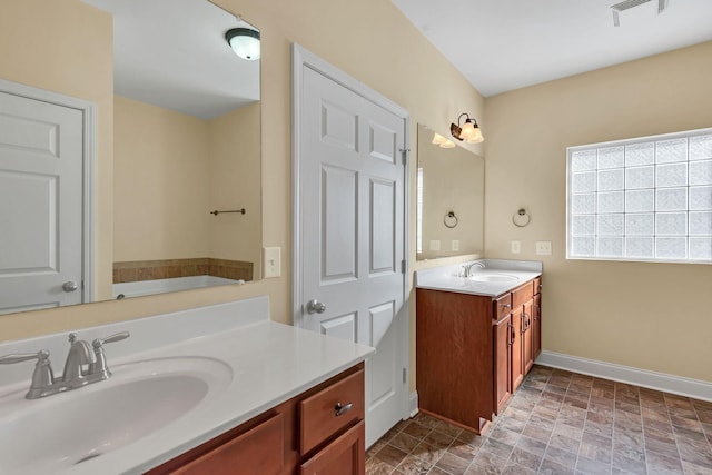 bathroom featuring vanity and a tub to relax in