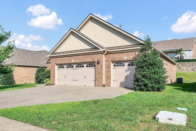 view of front of property with central AC unit, a front yard, and a garage