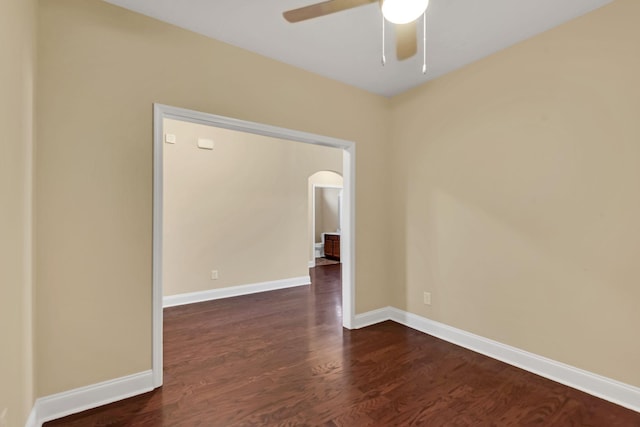 spare room with dark hardwood / wood-style floors and ceiling fan