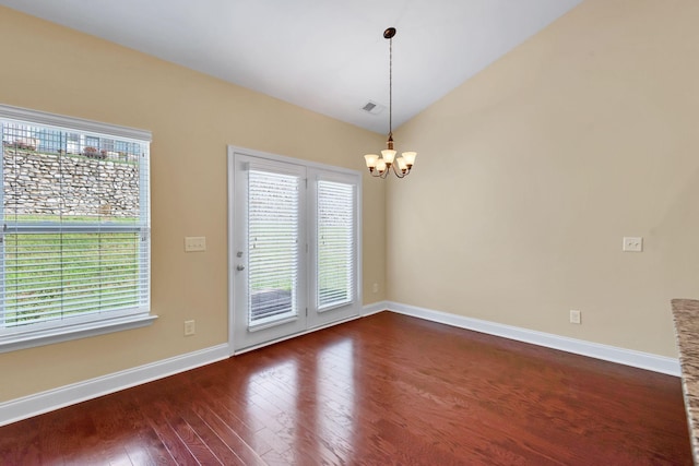 interior space featuring dark wood-type flooring, a chandelier, and lofted ceiling