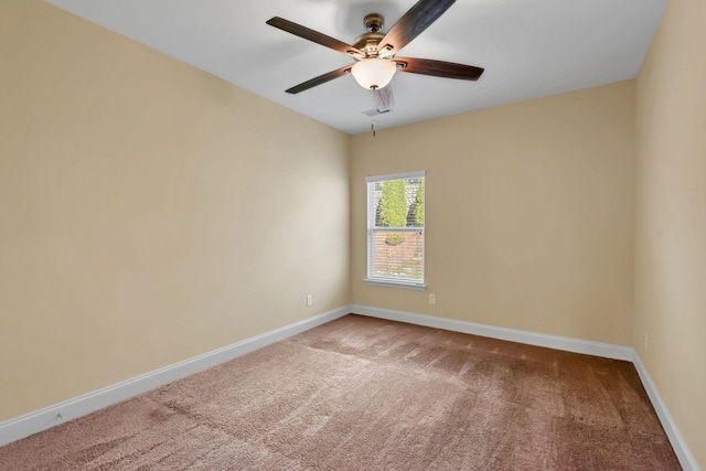 carpeted spare room featuring ceiling fan